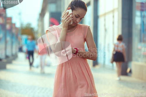 Image of Young Beautiful Woman Talking On Mobile Phone Outdoor.