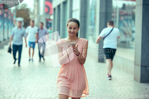 Image of Young Beautiful Woman Talking On Mobile Phone Outdoor.