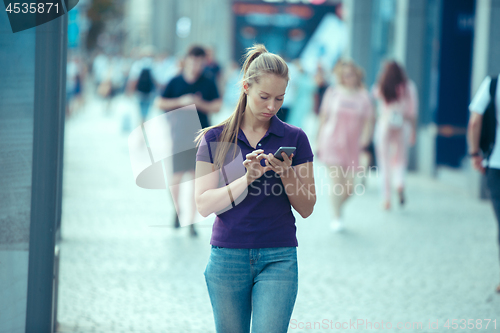 Image of Young Beautiful Woman Talking On Mobile Phone Outdoor.