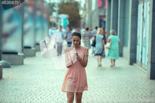 Image of Young Beautiful Woman Talking On Mobile Phone Outdoor.