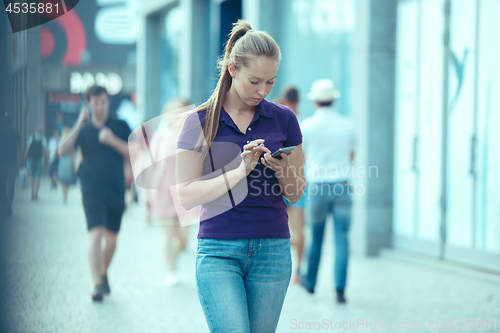 Image of Young Beautiful Woman Talking On Mobile Phone Outdoor.