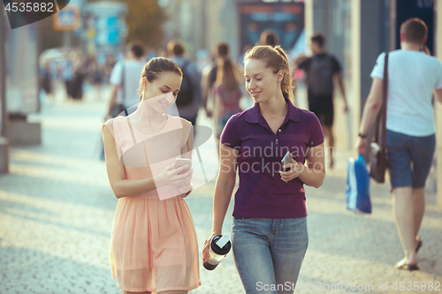 Image of Young Beautiful Women Talking On Mobile Phone Outdoor.