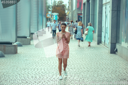 Image of Young Beautiful Woman Talking On Mobile Phone Outdoor.