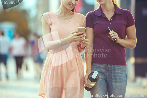 Image of Young Beautiful Women Talking On Mobile Phone Outdoor.