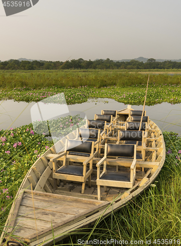 Image of tourist boat with chairs in the jungle river