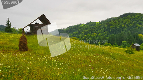 Image of Mountain huts on green hill