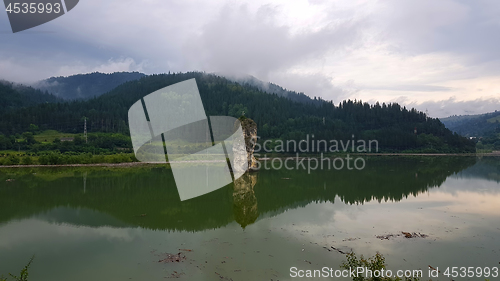 Image of Rock and lake, surrounded by the forest
