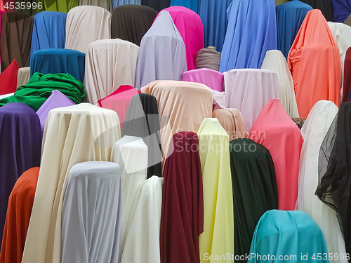 Image of Colorful rolls of satin fabrics for sale in the market