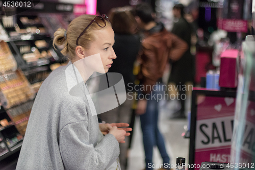 Image of Women buying and testing cosmetics in a beauty store