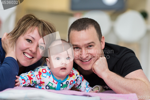 Image of Portrait of young happy couple with their adorable baby boy