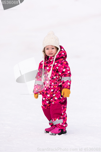 Image of little girl having fun at snowy winter day