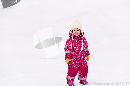 Image of little girl having fun at snowy winter day