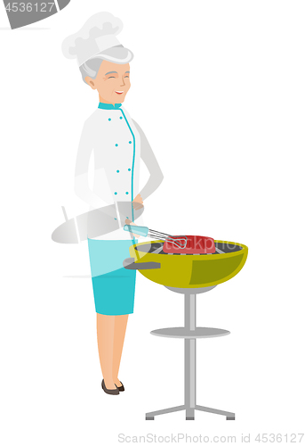 Image of Caucasian chef cooking meat on barbecue grill.