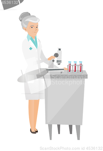 Image of Laboratory assistant working with microscope.