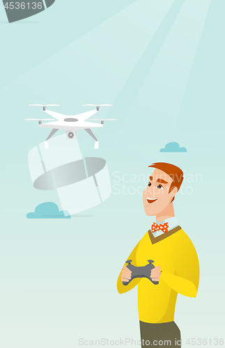 Image of Young caucasian man flying drone.