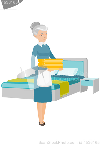 Image of Caucasian housekeeping maid with stack of linen.