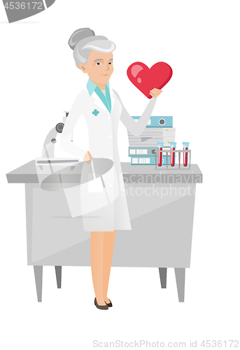 Image of Caucasian cardiologist holding a big red heart.