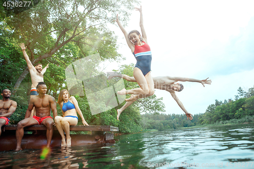 Image of Enjoying river party with friends. Group of beautiful happy young people at the river together