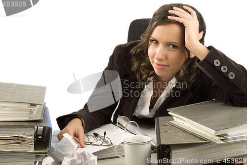 Image of Young secretary with disorganized desktop