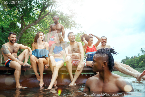 Image of Enjoying river party with friends. Group of beautiful happy young people at the river together