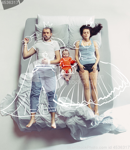 Image of Top view of happy family with one newborn child in bedroom and their dreams .