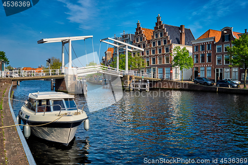Image of Spaarne river with boat and Gravestenenbrug bridge in Haarlem, N