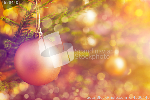 Image of Christmas-tree decoration bauble on decorated Christmas tree bac