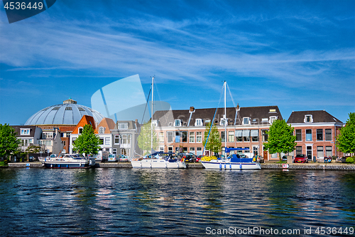 Image of Boats and houses on Spaarne river. Haarlem, Netherlands