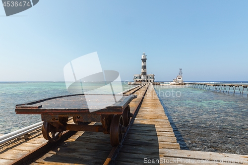 Image of Railcart on pier with lighthouse