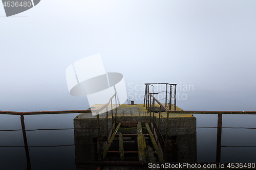 Image of Damaged pier in the mist at morning