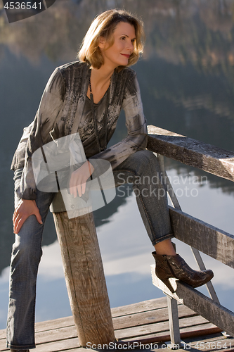 Image of Fashionably dressed elderly lady enjoys 