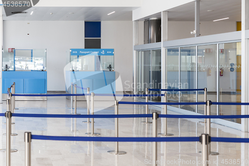 Image of Blue passport control cabines at the empty airport terminal