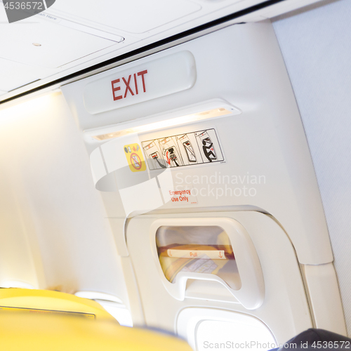 Image of Closeup shot of emergency exit door in airplane