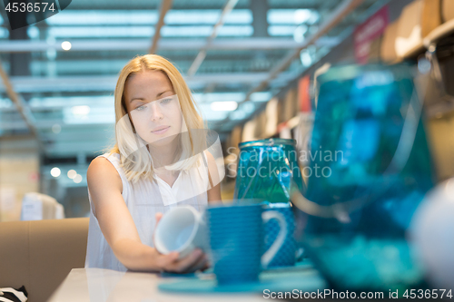 Image of Beautiful young woman shopping in retail store.