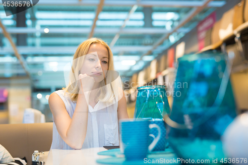 Image of Beautiful young woman shopping in retail store.