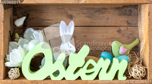 Image of word easter in german language with decoration in a wooden box