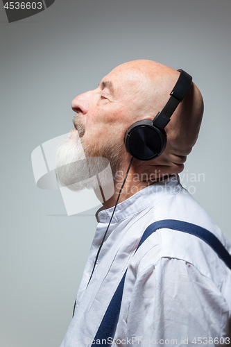 Image of elderly bald head man with headphones