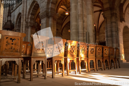 Image of a row of wooden chairs in an old church