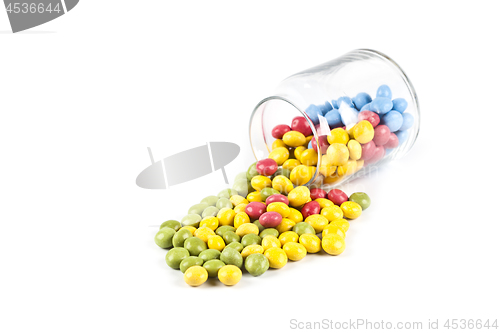 Image of Colorful sweet candies in glass jar isolated on white.