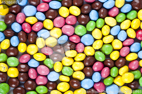 Image of Pile of delicious rainbow colorful chocolate candies background.