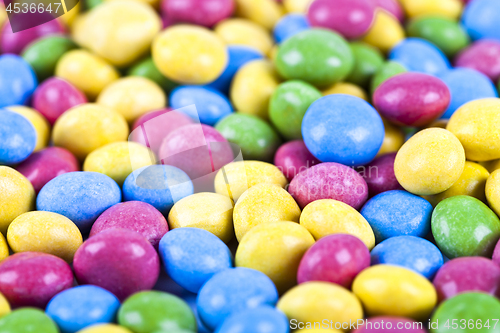 Image of Pile of delicious ainbow colorful chocolate candies background.