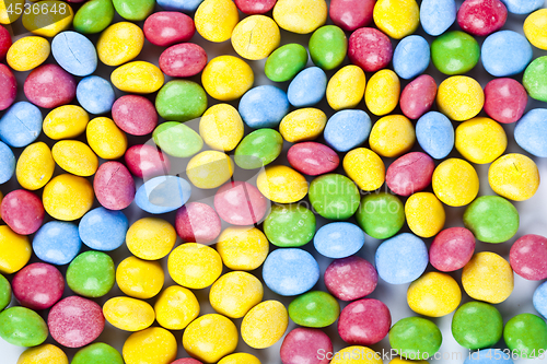 Image of Pile of delicious rainbow colorful chocolate candies background.