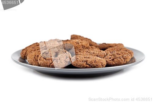 Image of Fresh baked chocolate chip cookies heap on grey plate isolated o