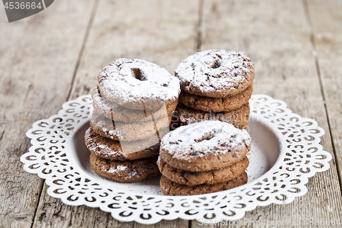 Image of Fresh baked chocolate chip cookies with sugar powder heap on whi