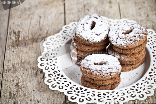 Image of Fresh baked chocolate chip cookies with sugar powder heap on whi