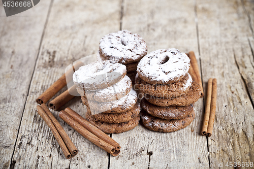 Image of Fresh baked chocolate chip cookies with sugar powder and cinnamo