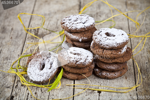 Image of Fresh baked chocolate chip cookies with sugar powder stacks on w