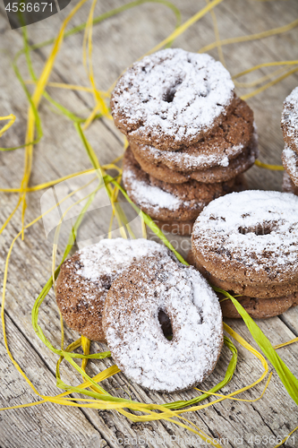 Image of Fresh baked chocolate chip cookies with sugar powder stacks on w