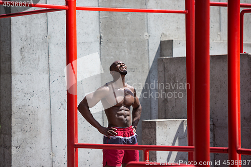 Image of Athlete doing exercises at stadium