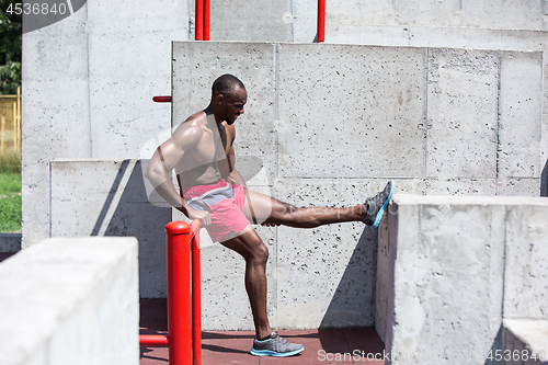 Image of Athlete doing exercises at stadium